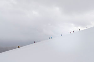 Climber on the way to the Bishorn summit, roped on during a blizzard and heavy fog over the glacier Climber on the way to the Bishorn summit, roped on during a blizzard and heavy fog over the glacier